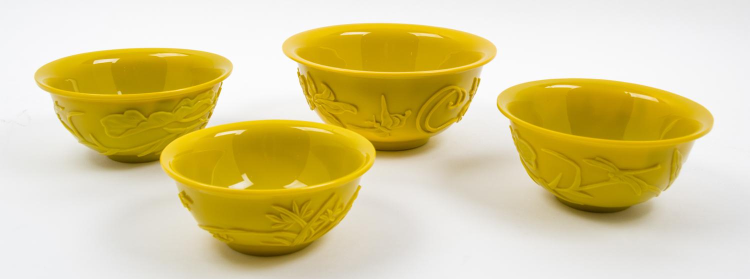 Four Yellow Peking Glass Bowls Diameter of largest 8 inches.