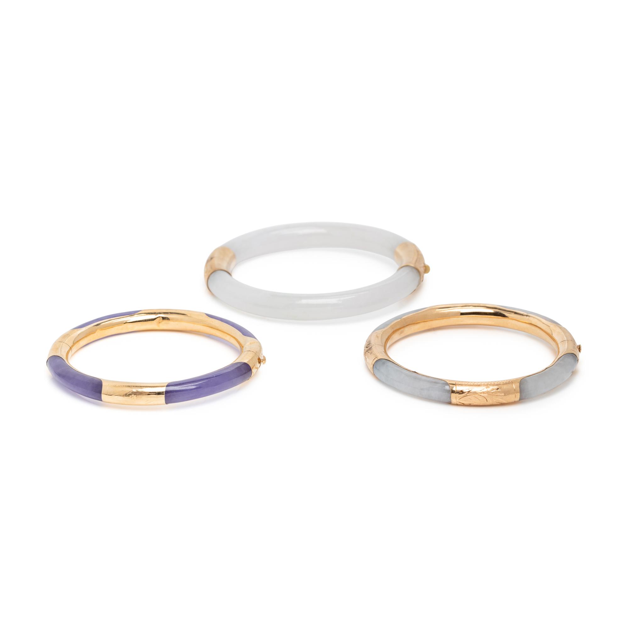 THREE JADE AND YELLOW GOLD BANGLE BRACELETS