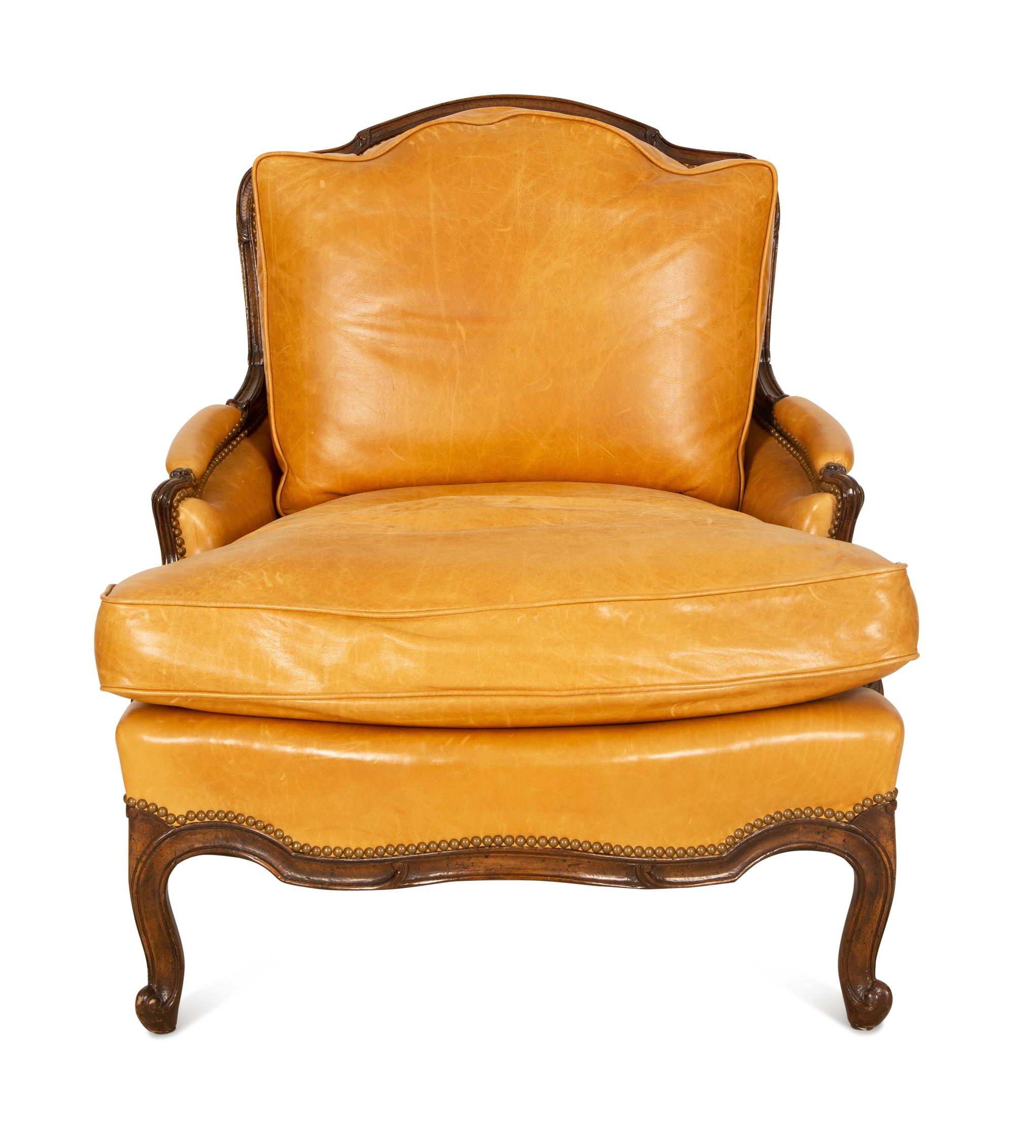 A Louis XVI Style Carved Mahogany Leather Upholstered Bergeré — 20th Century