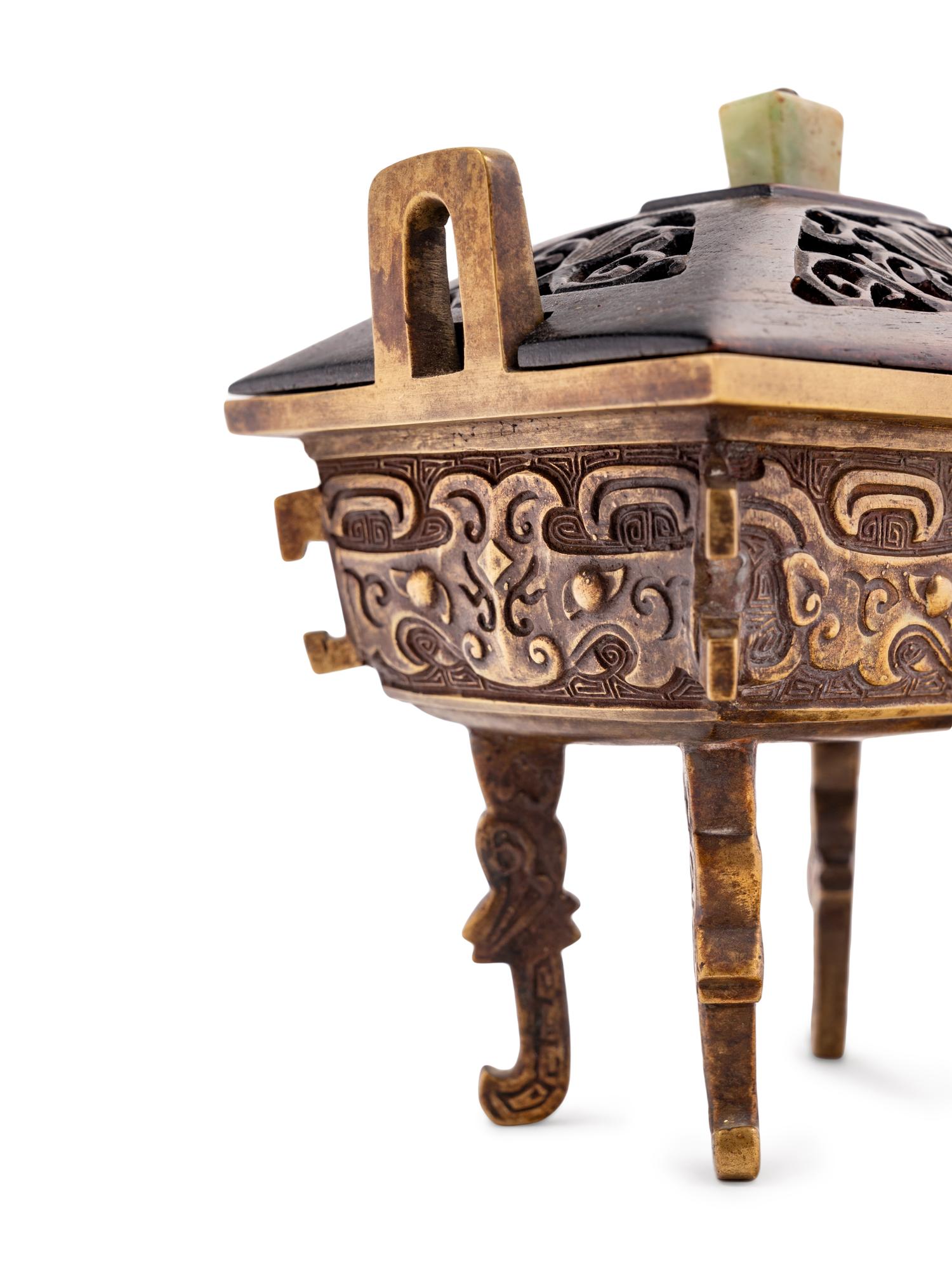 A Chinese Parcel-Gilt Bronze Ding- Form Incense Burner