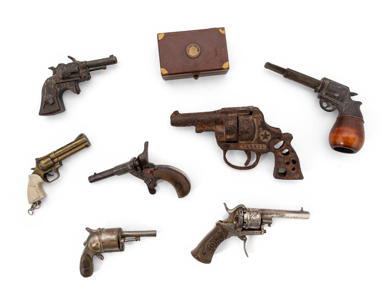 A Group of Eight Miniature Firearms Related Accoutrements