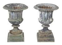 A Pair of Patinated Metal Campana Form Urns Height 24 x diameter 16 1/2 inches.