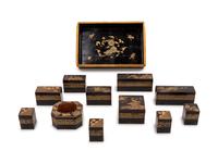 A Set of Eleven Small Japanese Gilt and Black Lacquer Stationary Boxes