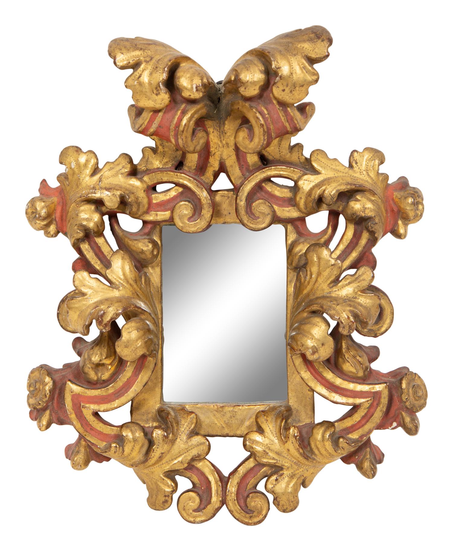 An Italian Rococo Style Red and Parcel Gilt Carved Wood Mirror
