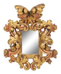 An Italian Rococo Style Red and Parcel Gilt Carved Wood Mirror