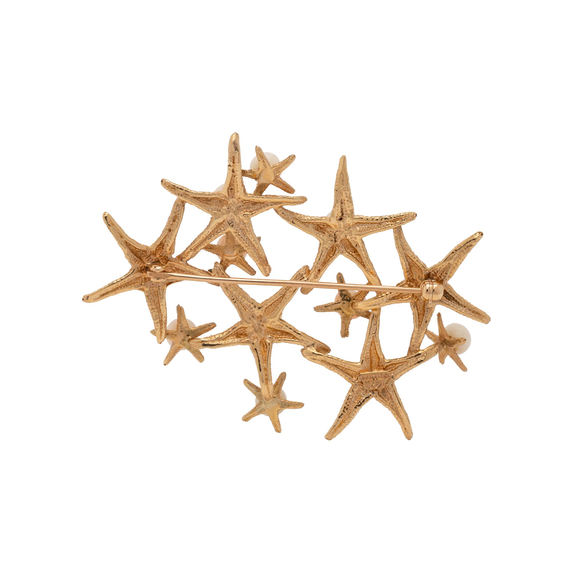 CELLINO, YELLOW GOLD AND CORAL STARFISH BROOCH