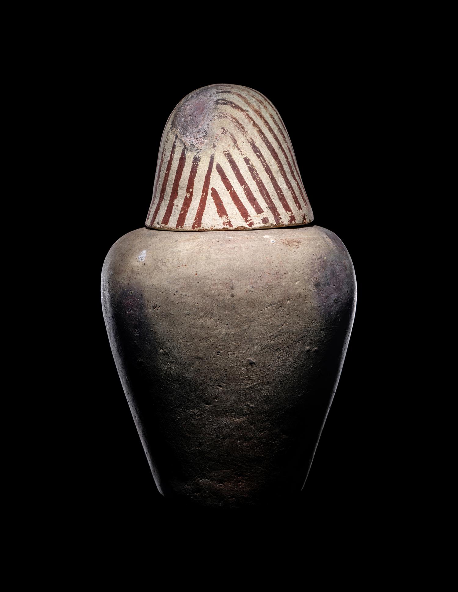 An Egyptian Painted Pottery Canopic Jar