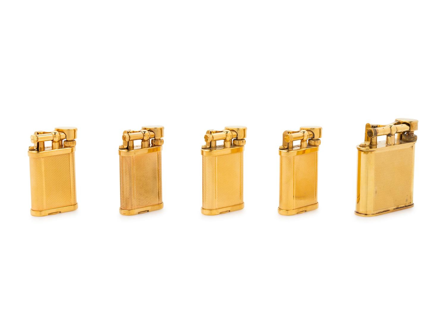 A Group of Five Gilt Metal Dunhill Lift-Arm Lighters