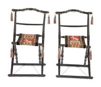 A Pair of Napoleon III Ebonized Folding Chairs with Needlepoint Seats