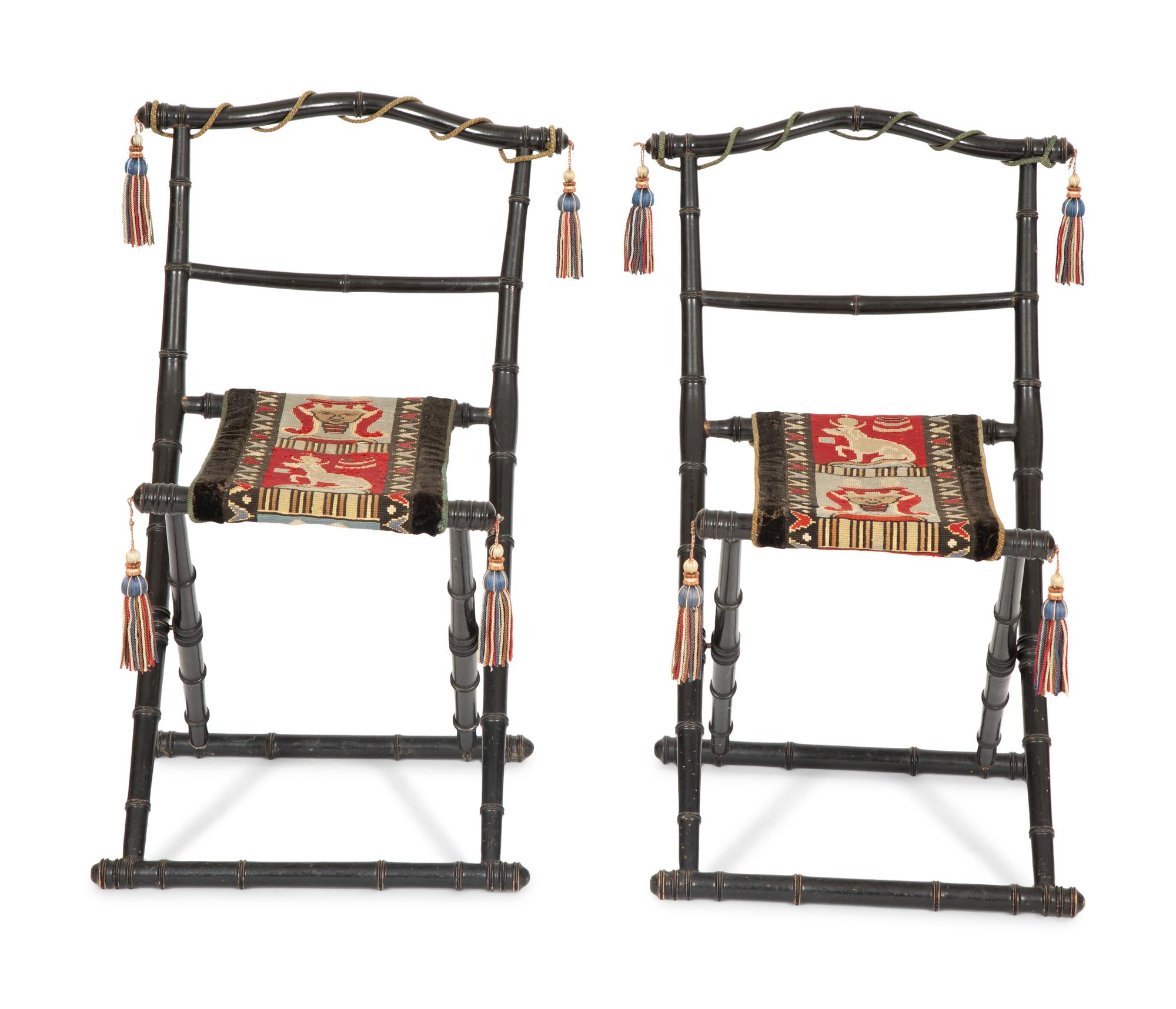 A Pair of Napoleon III Ebonized Folding Chairs with Needlepoint Seats