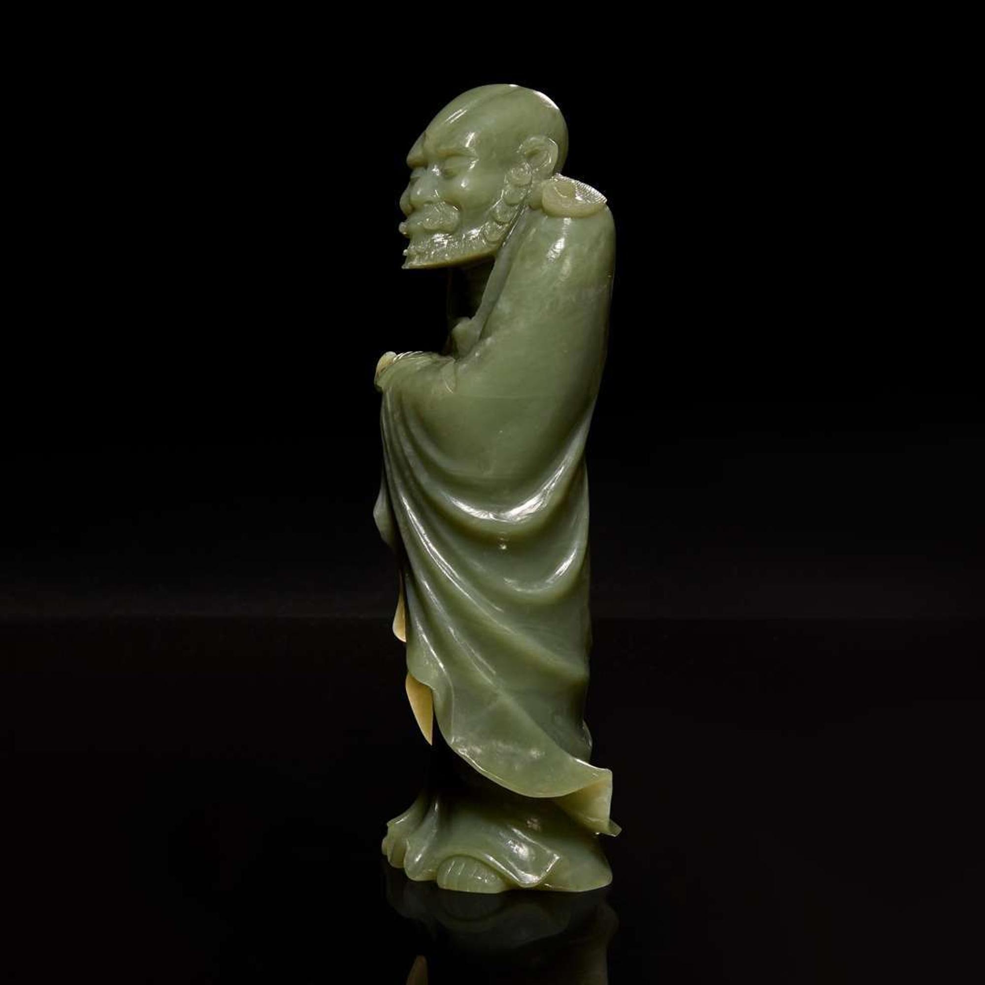 A Chinese carved celadon jade figure of a Lohan 青玉雕羅漢