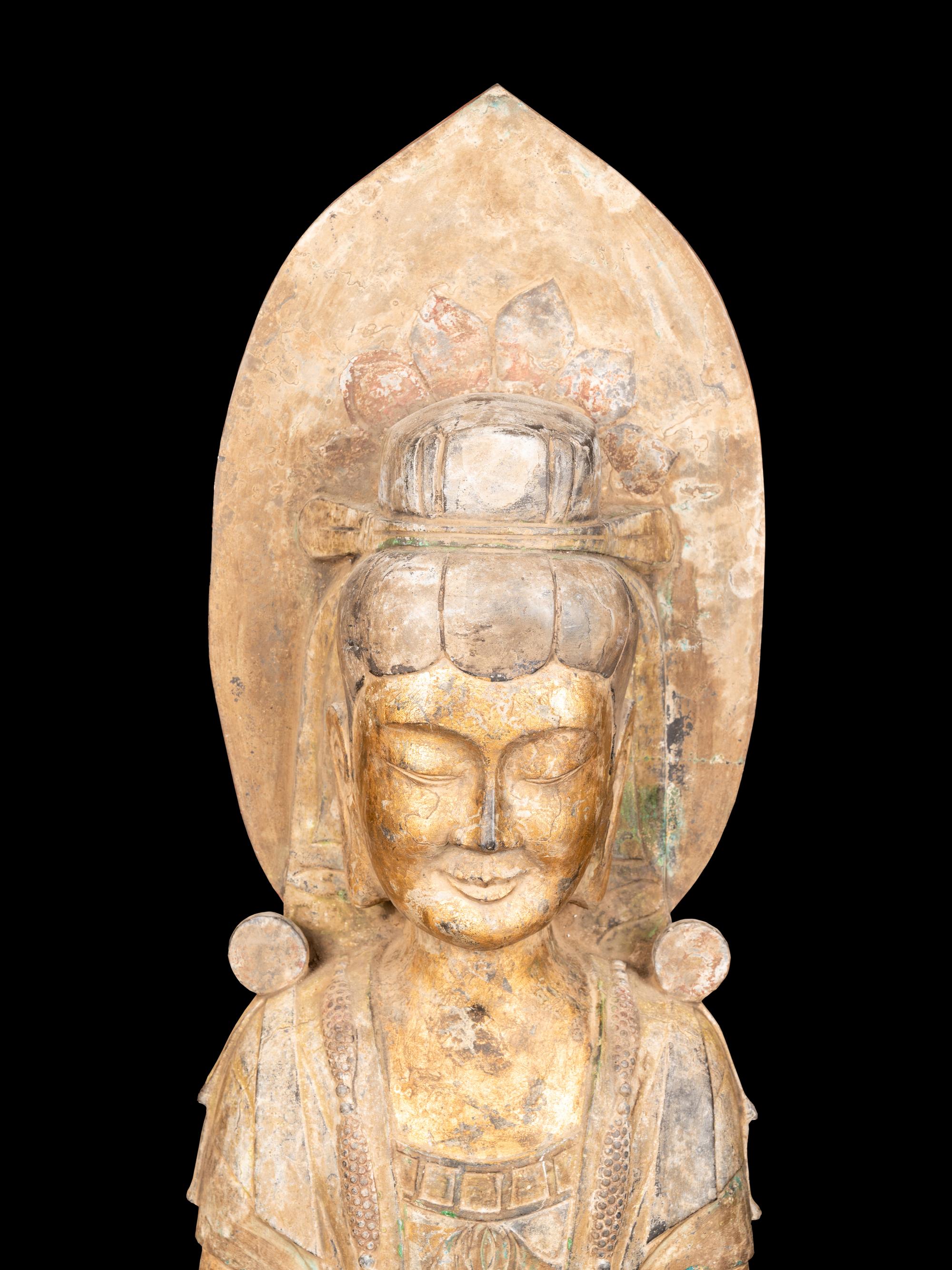 A Chinese Carved Stone Guanyin with Lotus Crown and Remnants of Gilt
