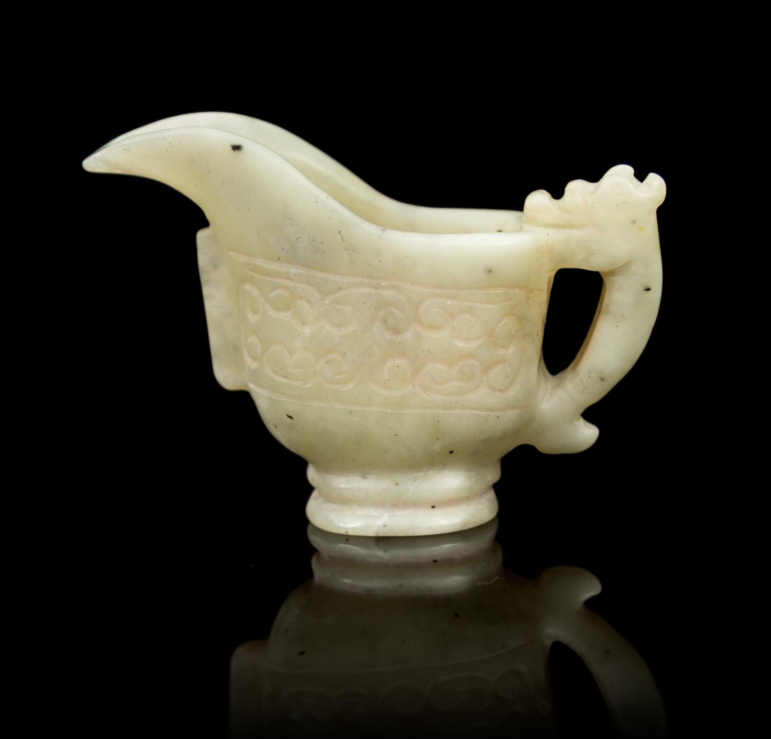 A Carved Jade Libation Cup Length overall 2 5/8 inches.
