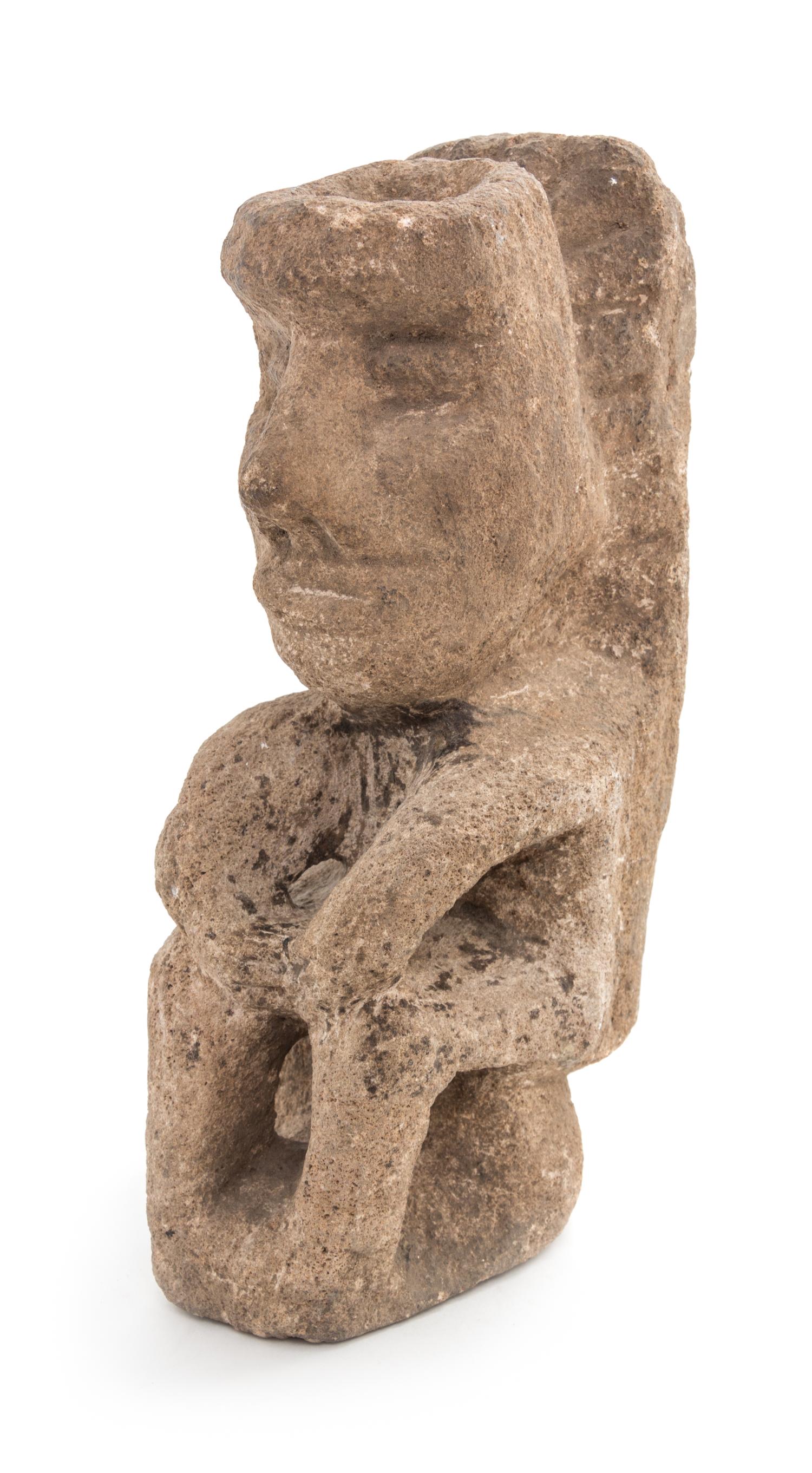 An Aztec Carved Stone Figure. Height 11 1/4 x width 3 3/4 x depth 5 3/4 inches.