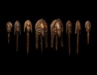 A Bamana Wood Marionette Figure with Eight Wood Puppet Heads