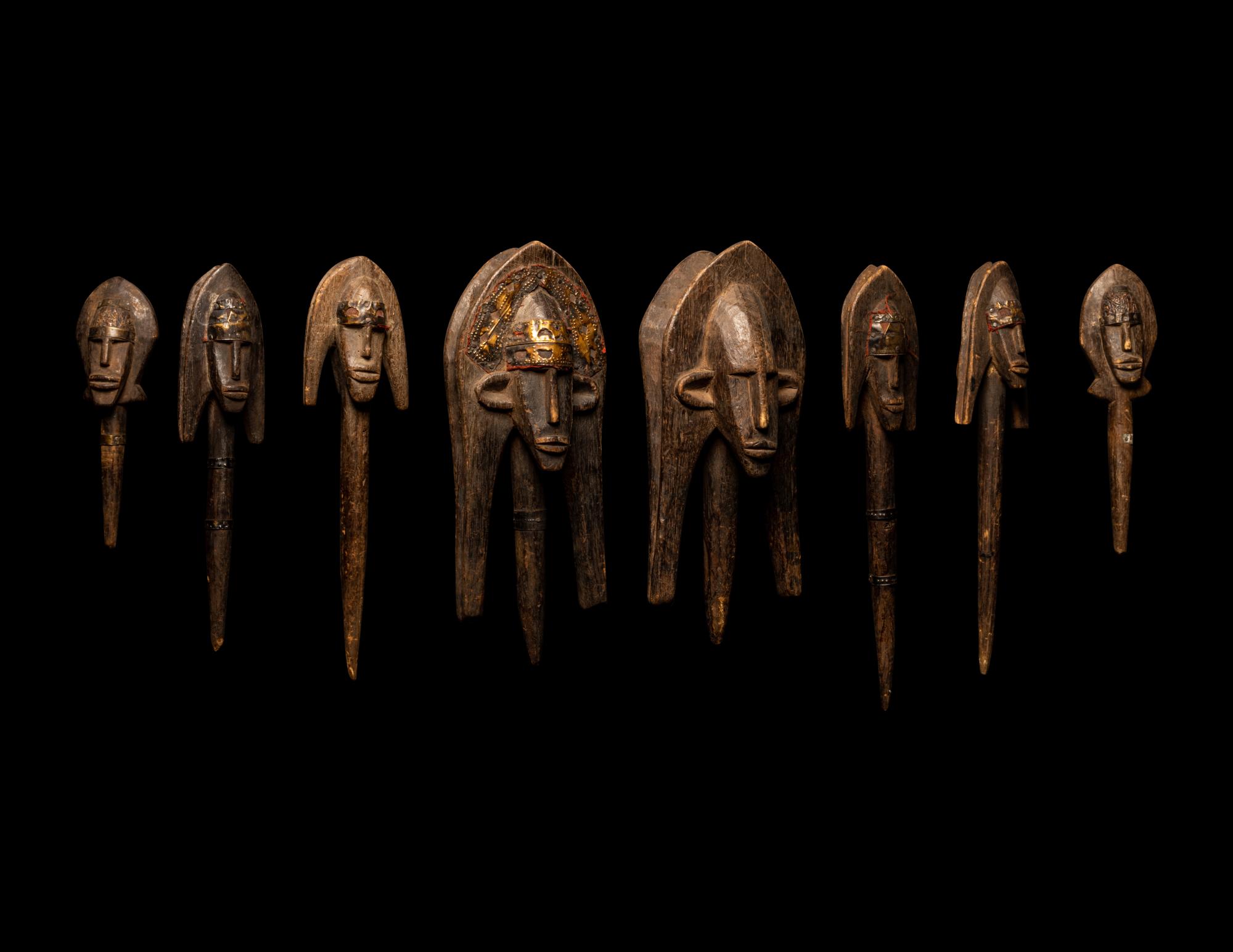 A Bamana Wood Marionette Figure with Eight Wood Puppet Heads