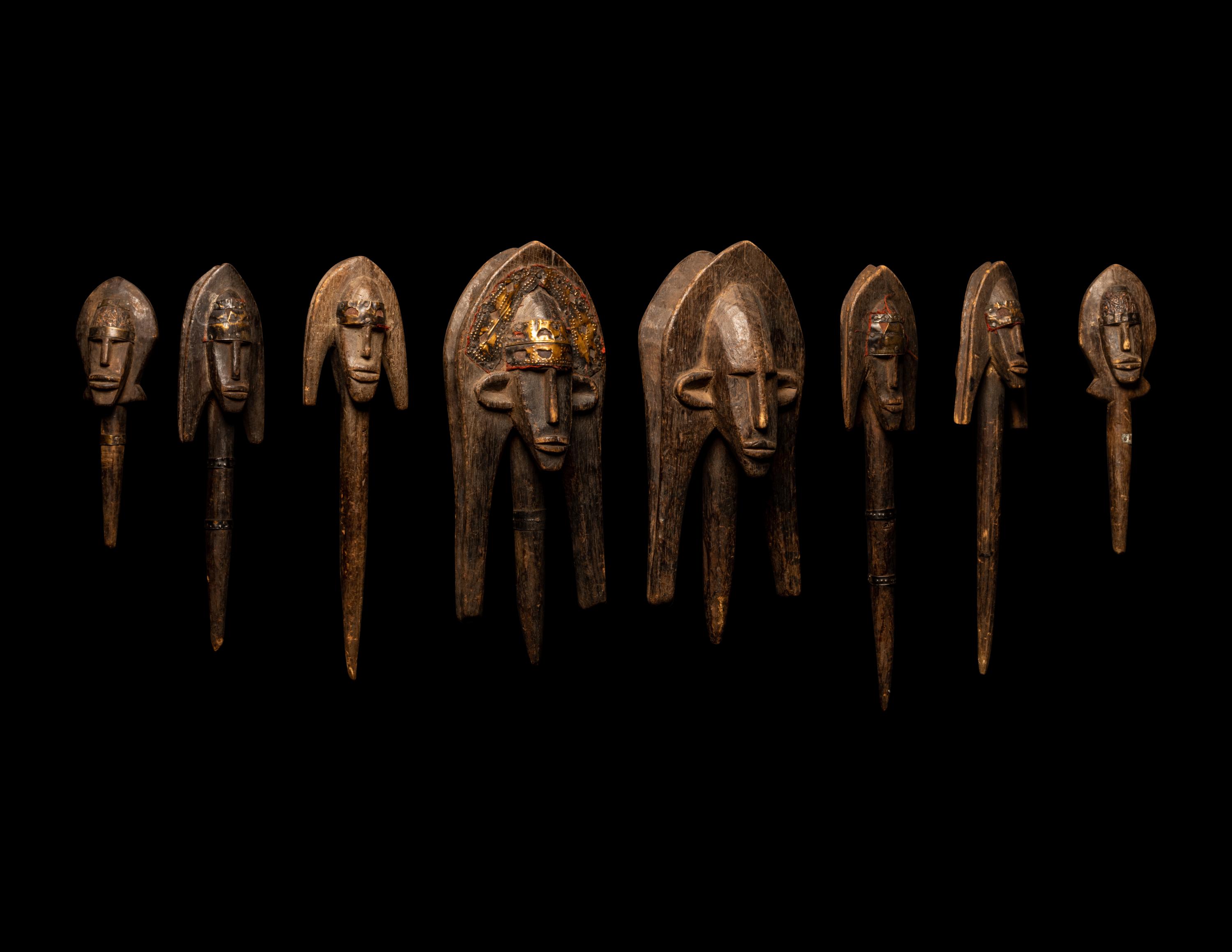 A Bamana Wood Marionette Figure with Eight Wood Puppet Heads