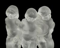 A Pair of Lalique Reverie Bookends and a Bacchantes Figural Group