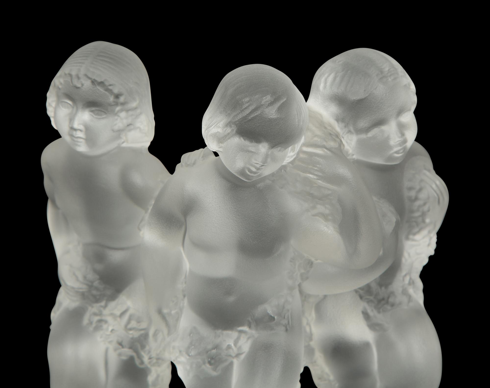 A Pair of Lalique Reverie Bookends and a Bacchantes Figural Group