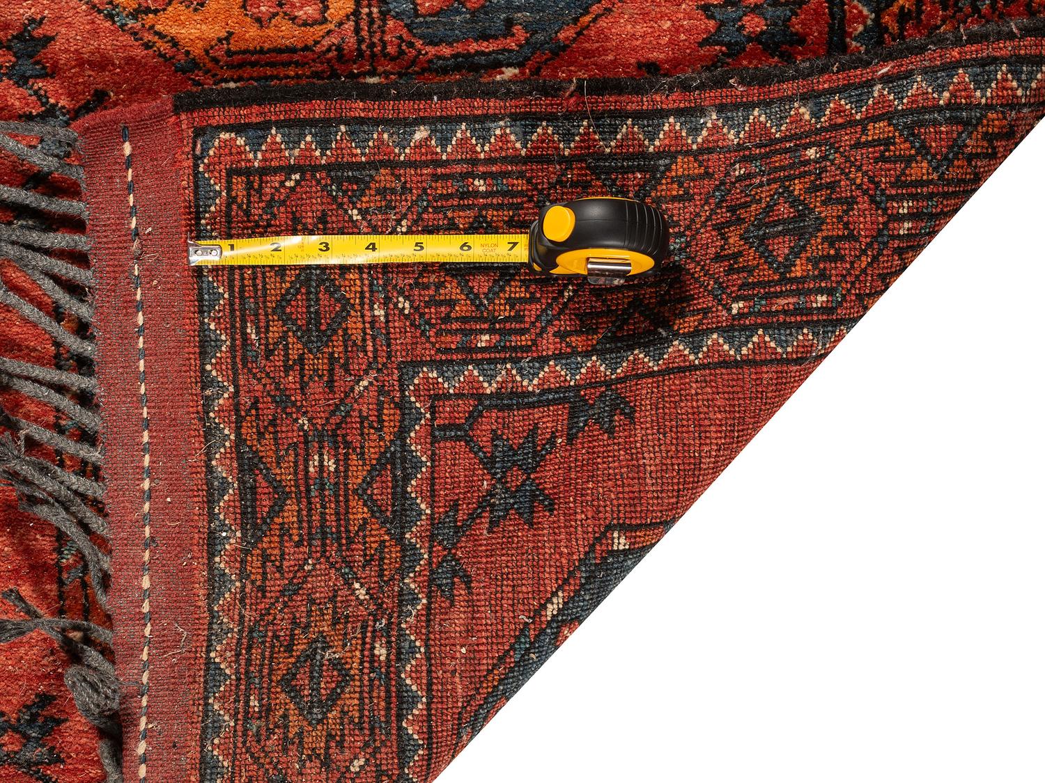 A Persian Wool Rug and Moroccan Saddle Mat