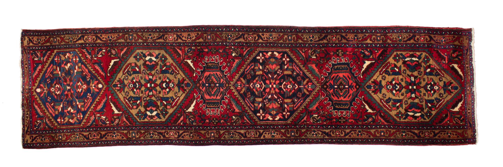 A Persian Wool Runner 10 feet 11 x 3 feet 1 inch. — 20TH CENTURY