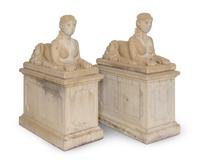 A Pair of Cast Stone Female Sphinxes on Pedestal Bases — 20TH CENTURY