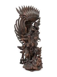 A Thai Carved Wood Figural Group of a Deity and Animals