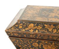 A Regency Black and Gilt Lacquer Box on Brass Paw Feet