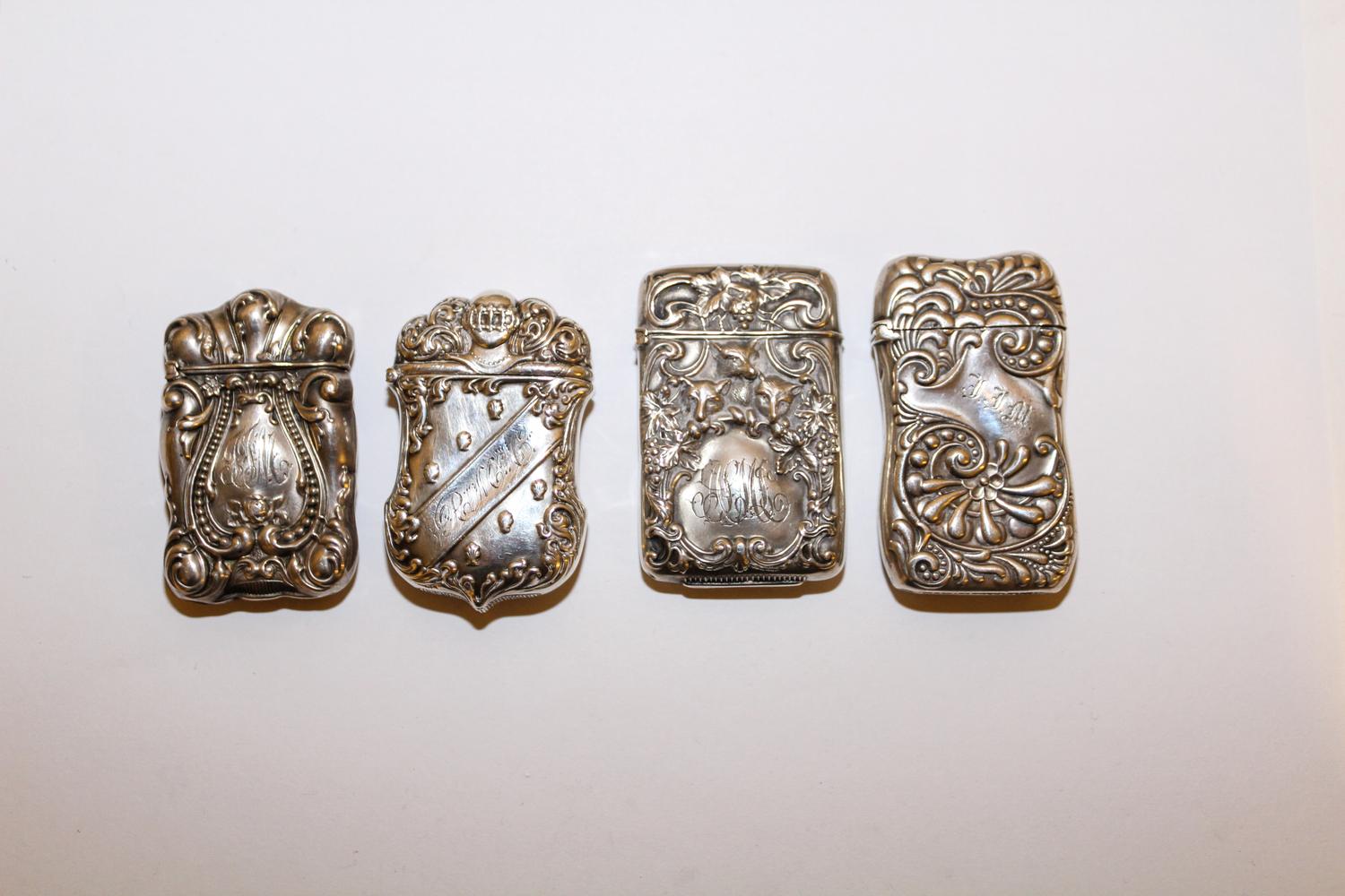 A Group of Four American Silver Vesta Cases, Various Makers, 19th Century, each engraved with monograms and repousse decorated.