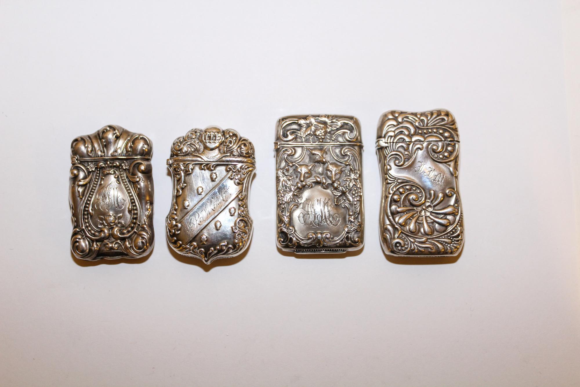 A Group of Four American Silver Vesta Cases, Various Makers, 19th Century, each engraved with monograms and repousse decorated.