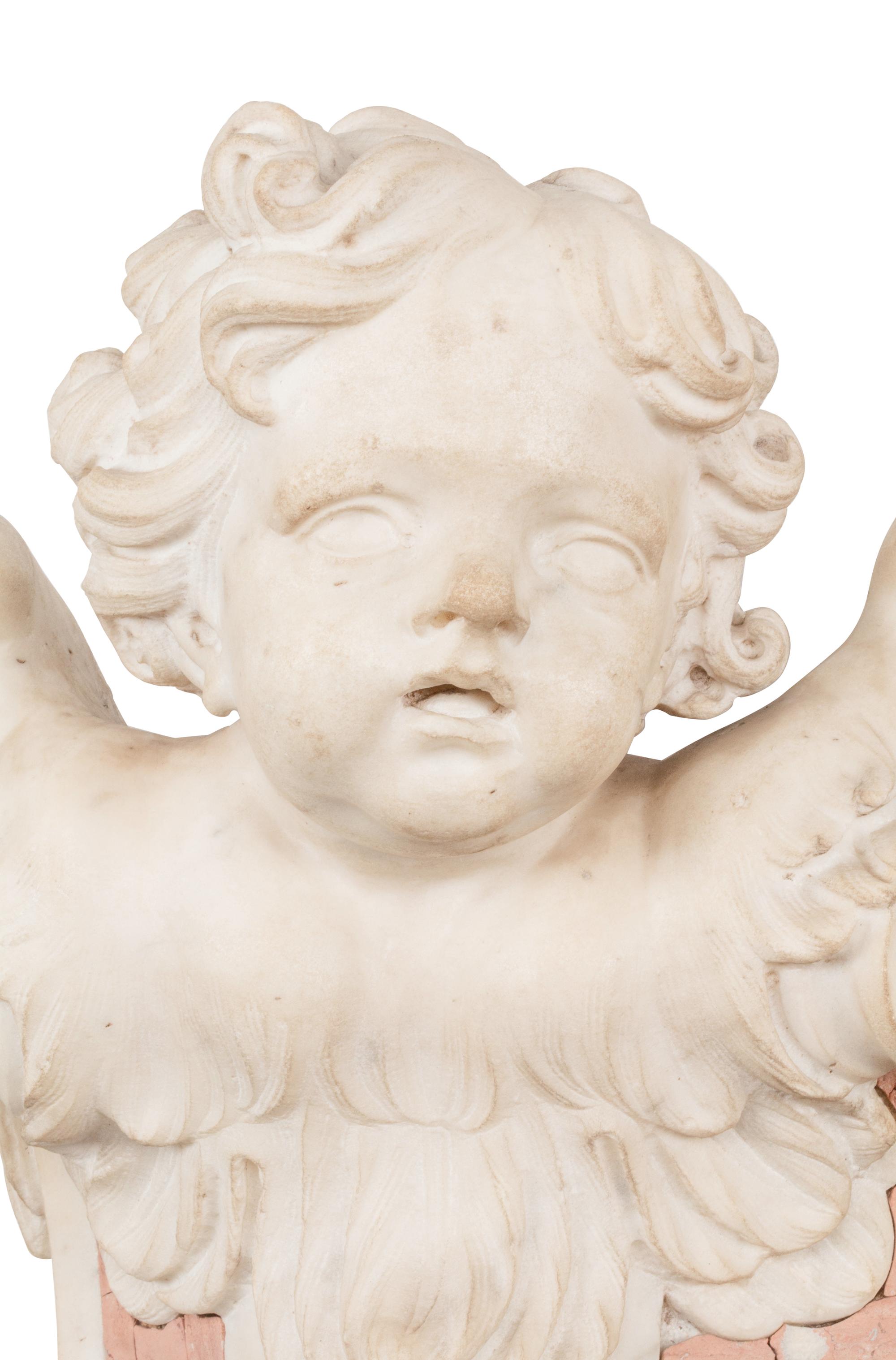 A Pair of Italian Carved Marble Figural Corbel Capitals