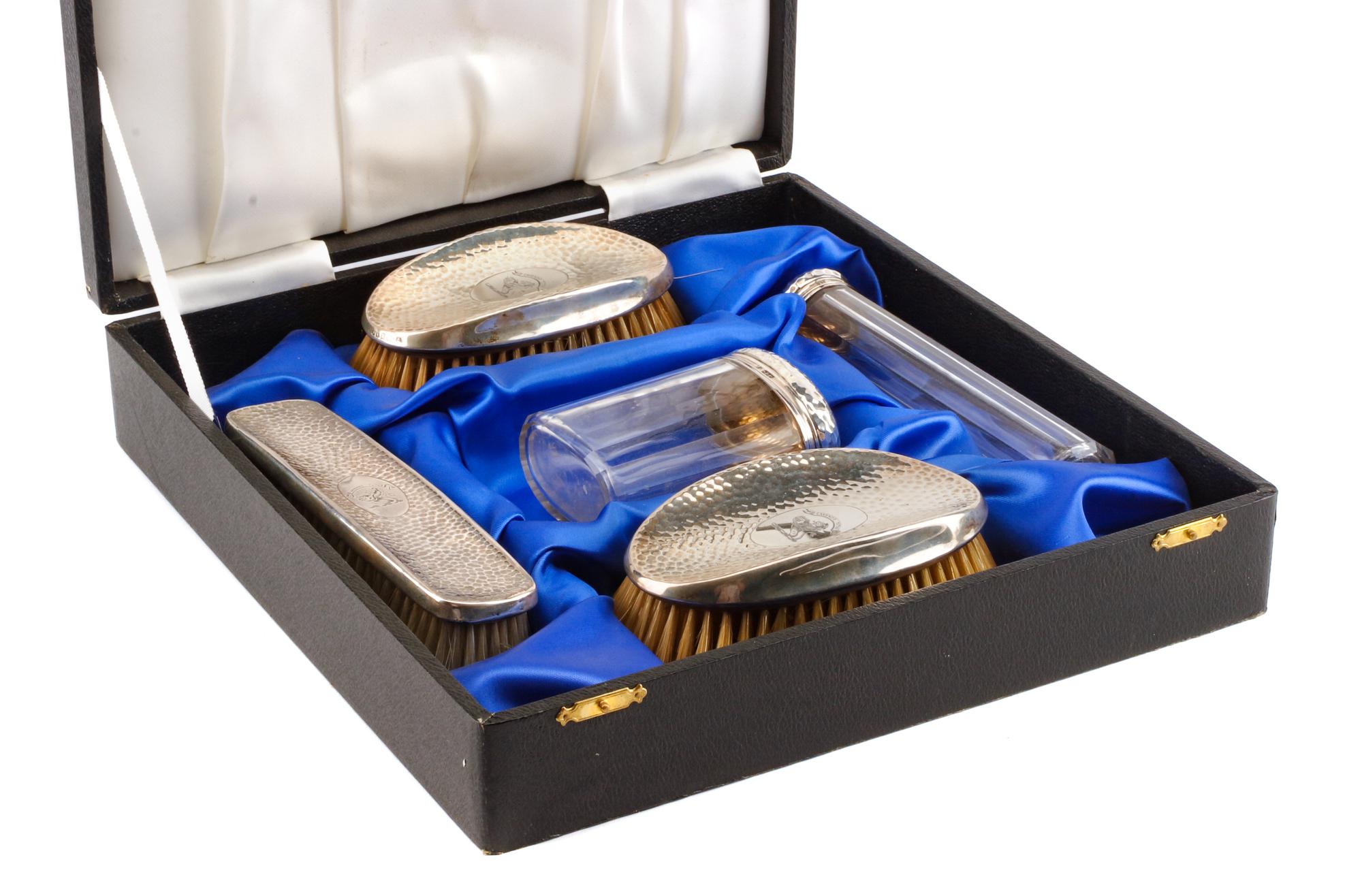 An Edwardian Silver Mounted Five-Piece Dresser Set, H. Matthews, Birmingham, 1902 and Others, comprising three brushes and two silver-m