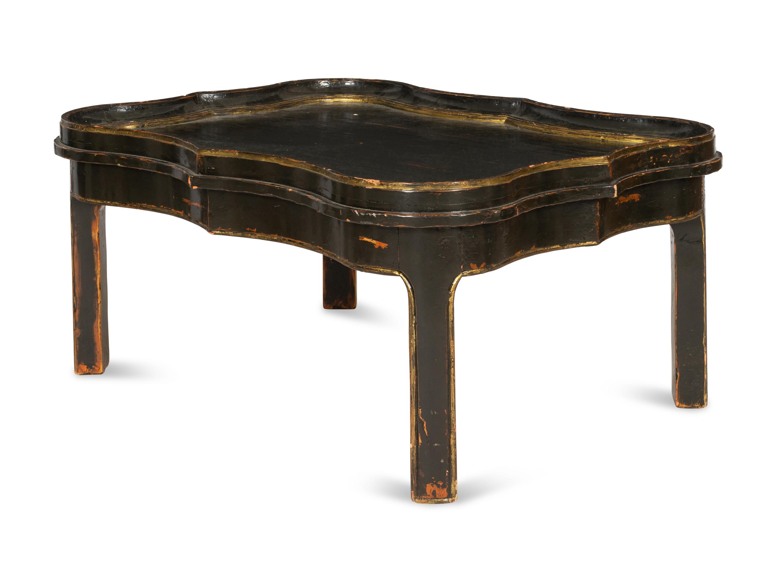 A Cartouche-Form Ebonized and Parcel Gilt Low Table