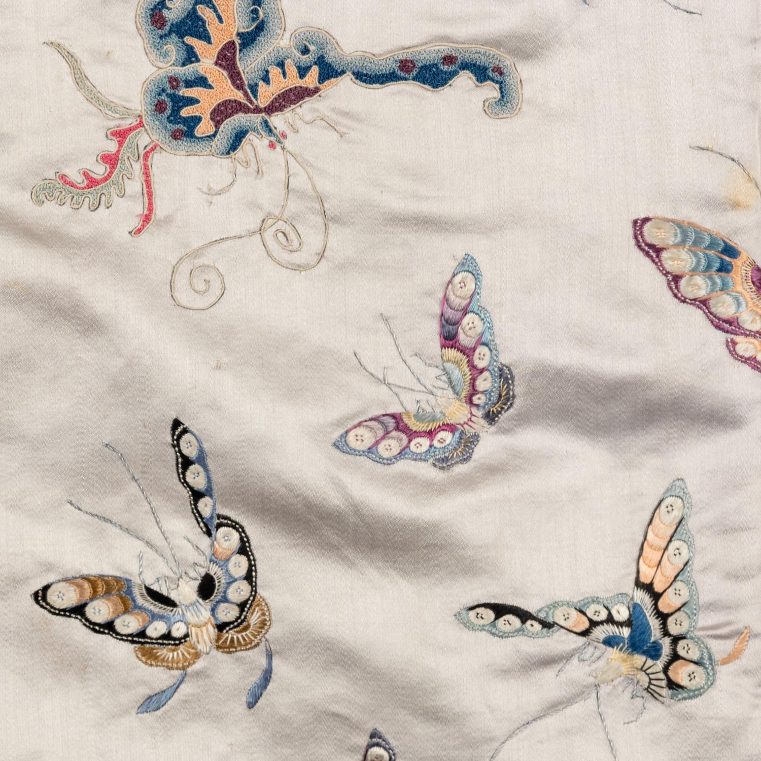 A Chinese Pale Blue Ground Embroidered Silk 'Butterfly' Lady's Informal Robe, Late Qing/Republic Period 晚清/民國 月白緞地百蝶紋女襖