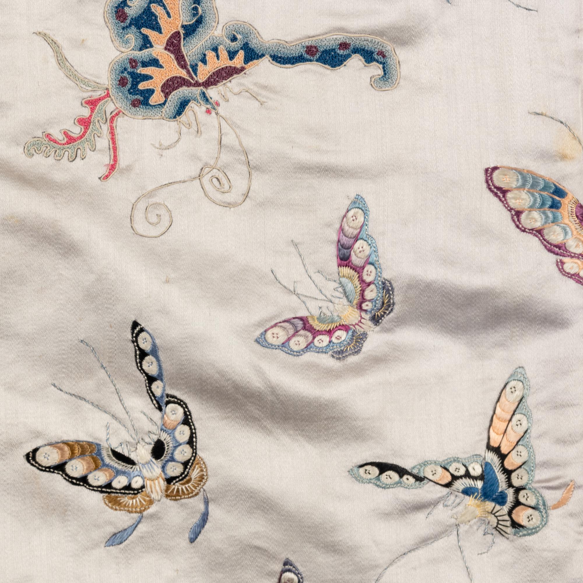 A Chinese Pale Blue Ground Embroidered Silk 'Butterfly' Lady's Informal Robe, Late Qing/Republic Period 晚清/民國 月白緞地百蝶紋女襖