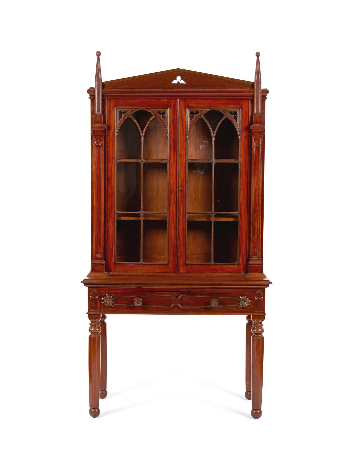 A Gothic Revival Carved Mahogany Display Cabinet on Stand — 19TH CENTURY