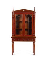 A Gothic Revival Carved Mahogany Display Cabinet on Stand — 19TH CENTURY