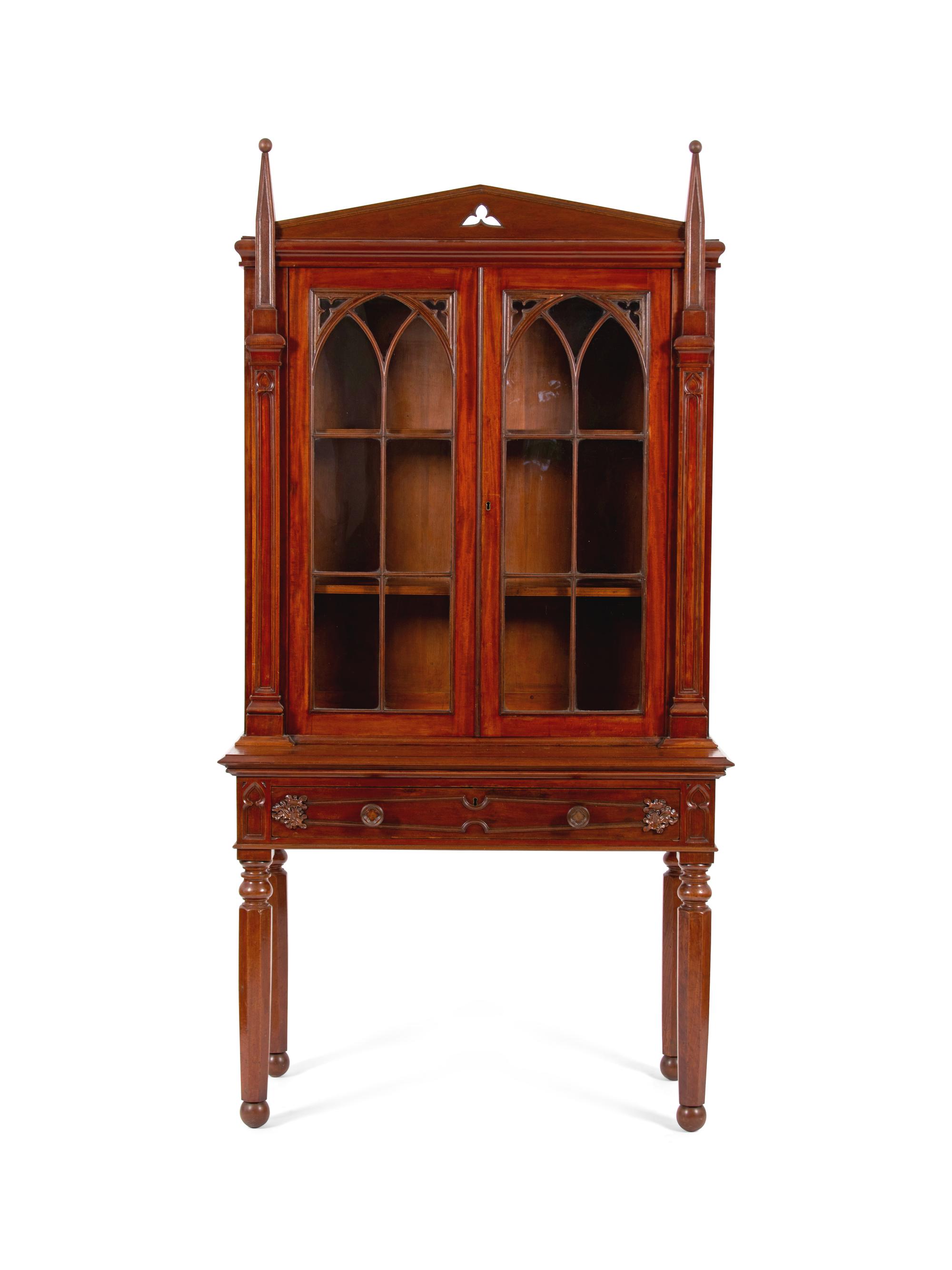 A Gothic Revival Carved Mahogany Display Cabinet on Stand — 19TH CENTURY