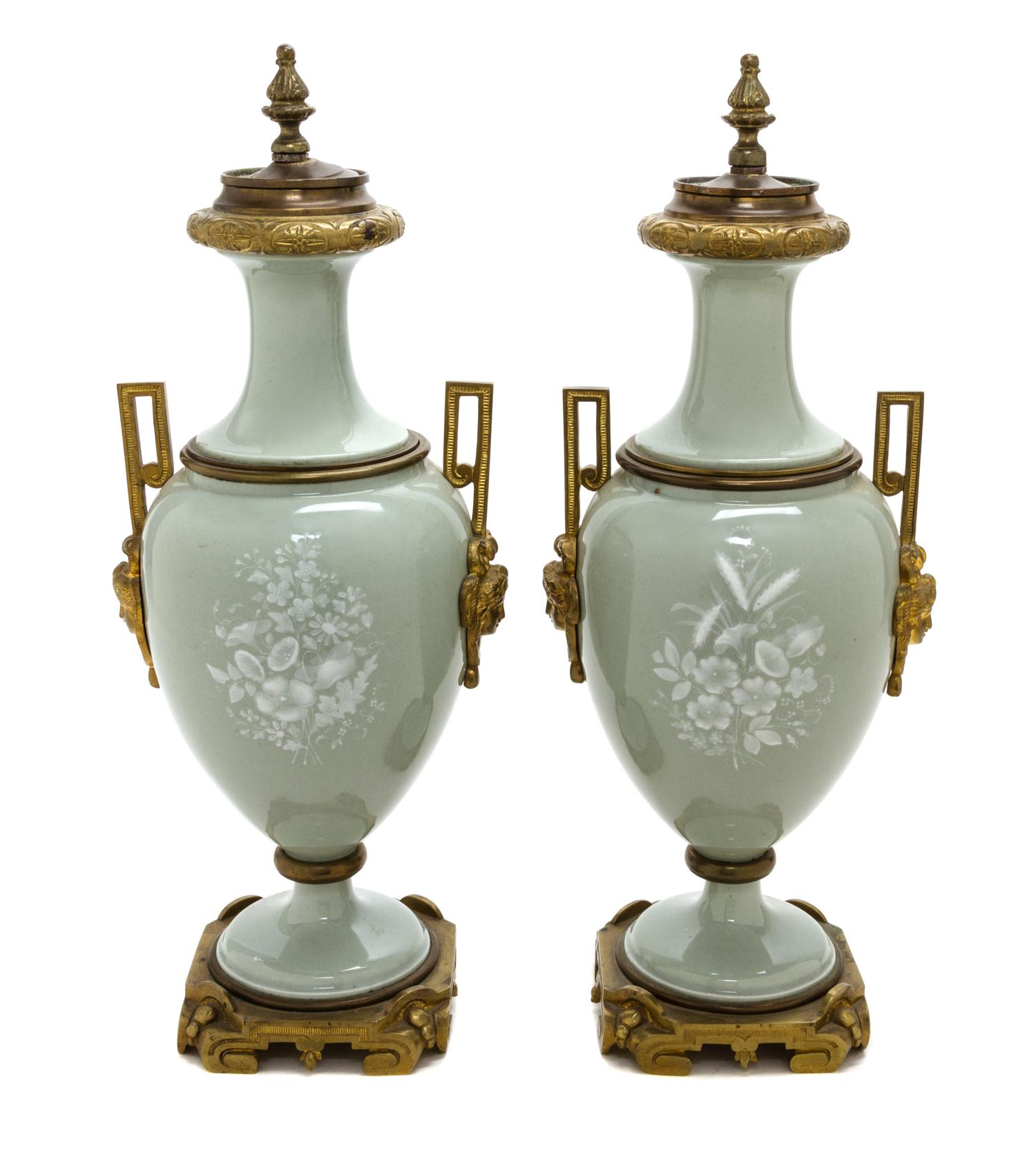 A Pair of Continental Gilt Bronze Mounted Pate-sur-Pate Urns and Covers, Height of each 18 inches.