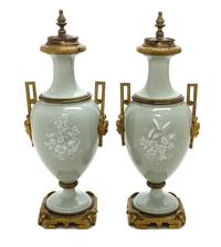 A Pair of Continental Gilt Bronze Mounted Pate-sur-Pate Urns and Covers, Height of each 18 inches.