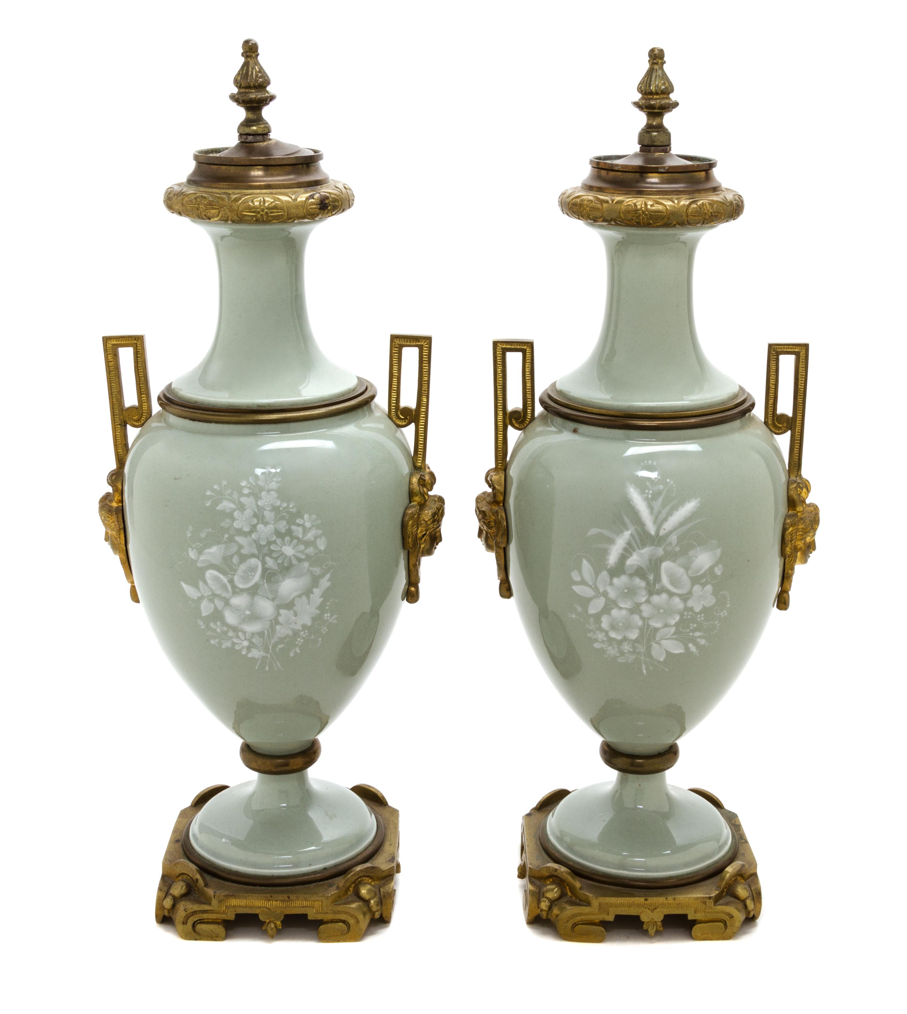 A Pair of Continental Gilt Bronze Mounted Pate-sur-Pate Urns and Covers, Height of each 18 inches.