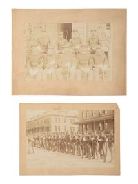 [BUFFALO SOLDIERS]. 2 photographs of "Buffalo Soldiers," Company D, 24th US Infantry, one credited to African American photographers J.P. BALL & SON, Helena, Montana. Ca 1902-1904.