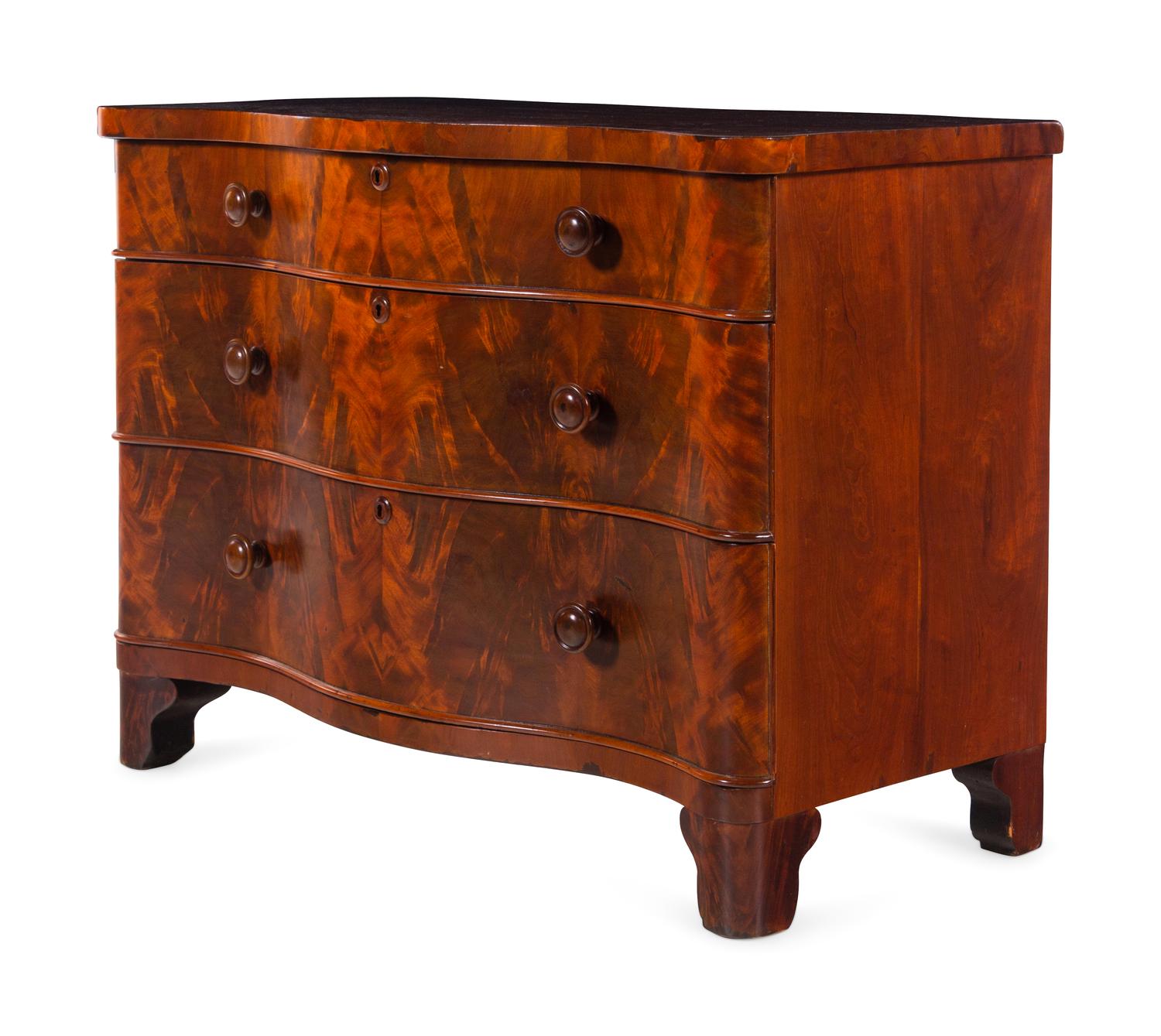 A Continental Walnut Serpentine-Front Chest of Drawers