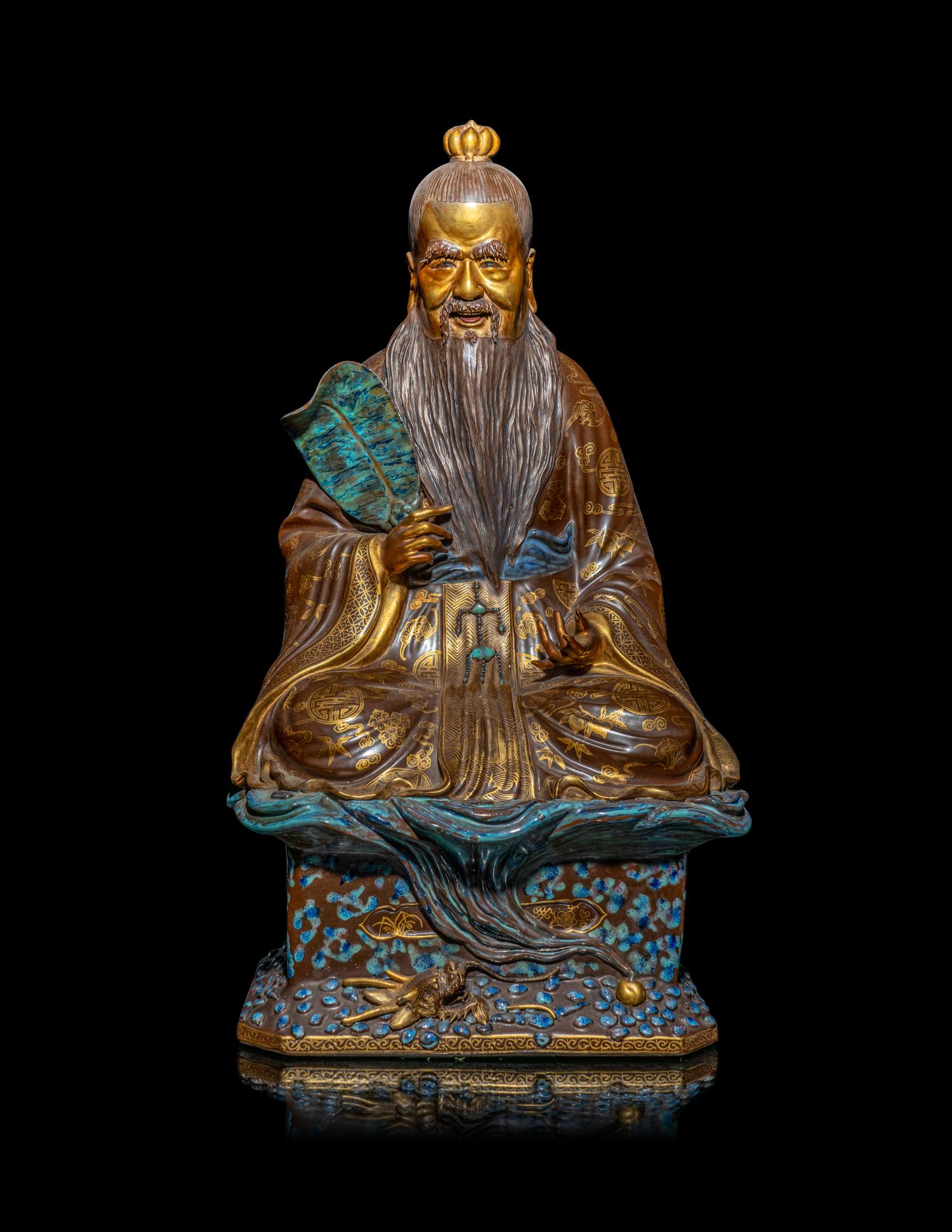A Chinese Gilt Highlighted Robin's Egg Glazed Porcelain Figure of an Immortal