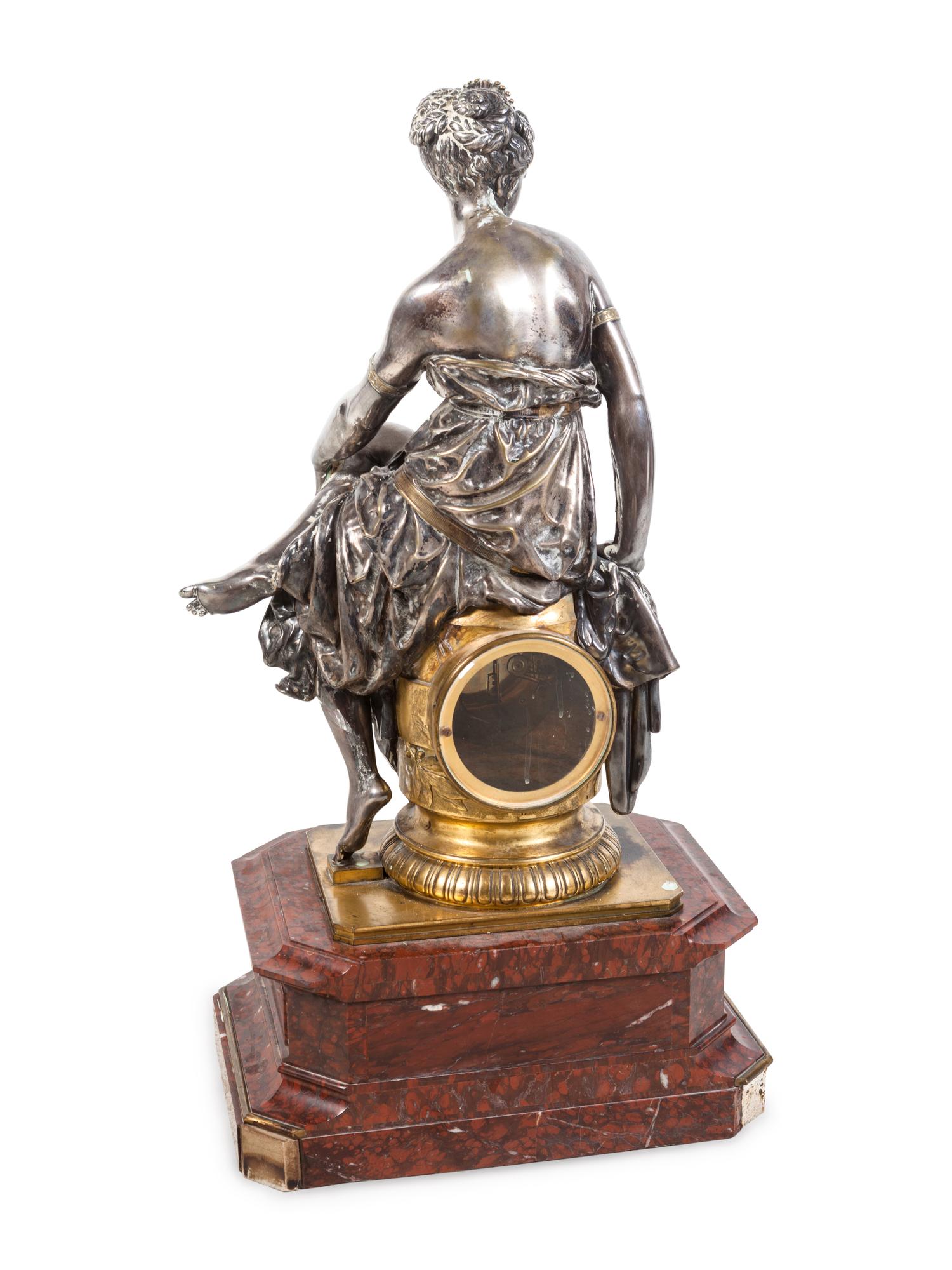 A Napoleon III Gilt and Silvered Bronze and Rouge Griotte Marble Figural Clock