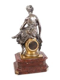 A Napoleon III Gilt and Silvered Bronze and Rouge Griotte Marble Figural Clock