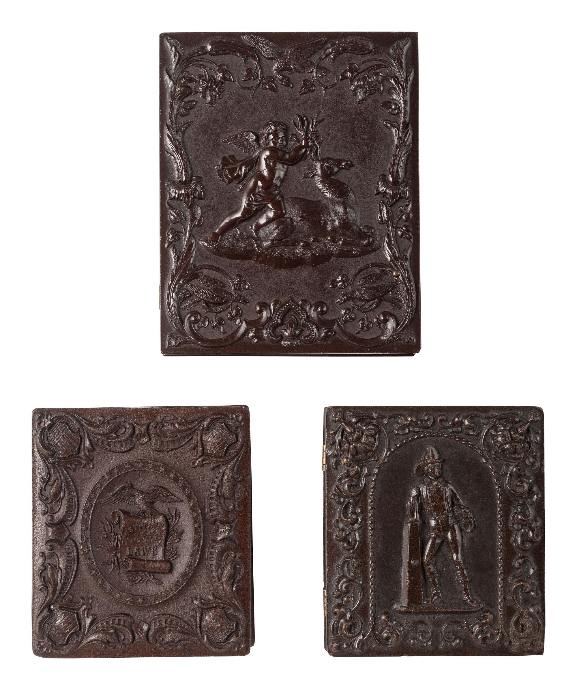[CIVIL WAR]. 3 tintype portraits of armed soldiers housed in figural Union cases.