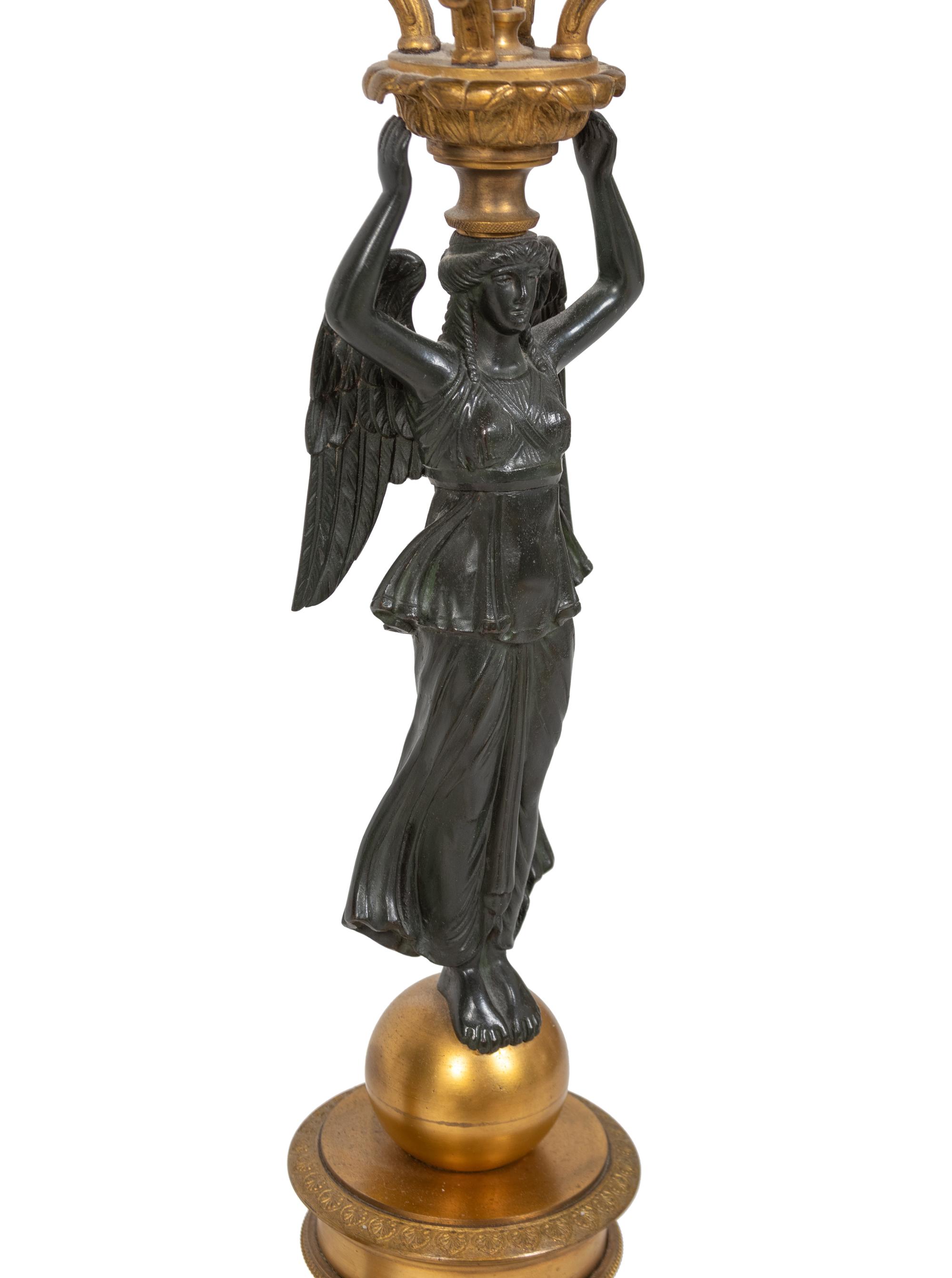 A Pair of Empire Style Parcel-Gilt and Patinated Bronze Four-Light Candelabra