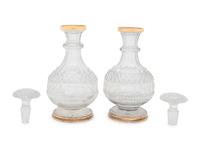 A Near Pair of George III Silver-Gilt Mounted Cut Glass Decanters