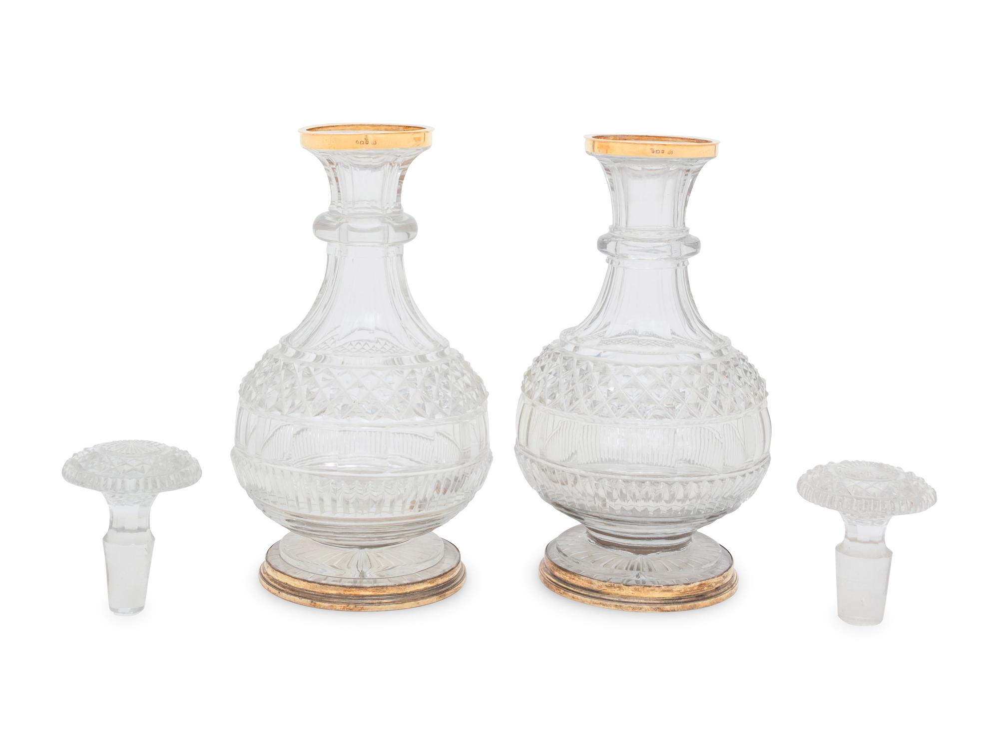A Near Pair of George III Silver-Gilt Mounted Cut Glass Decanters